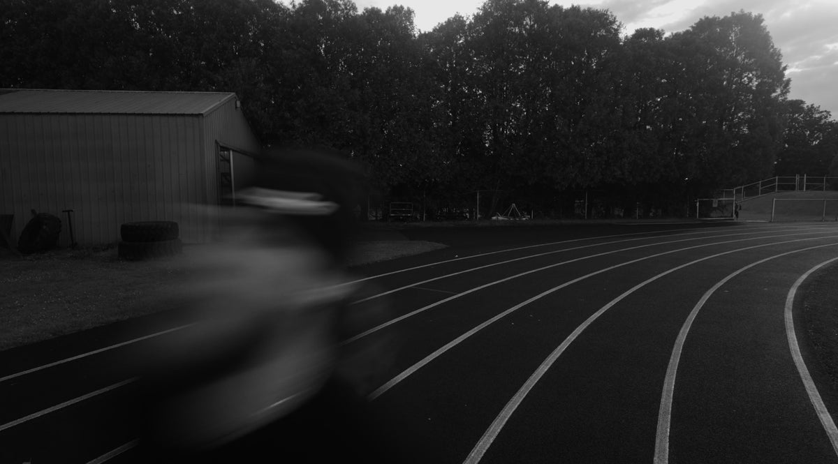 ARIZE ABOVE athlete sprinting on track